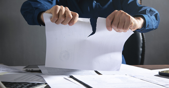 Businessman breaking contract at office