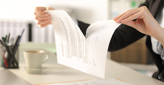 Business woman hands breaking document at the office