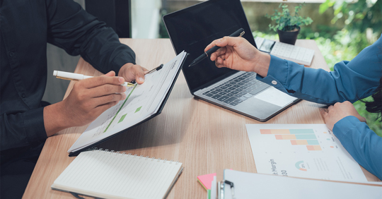 Two Hands Over Business Documents