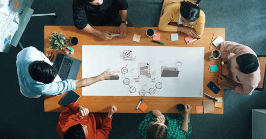 professionals collaborates around a wooden table