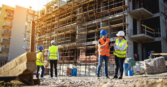 Construction workers looking over a project