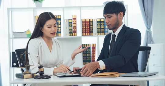lawyer and client discuss legal matters in a professional office setting