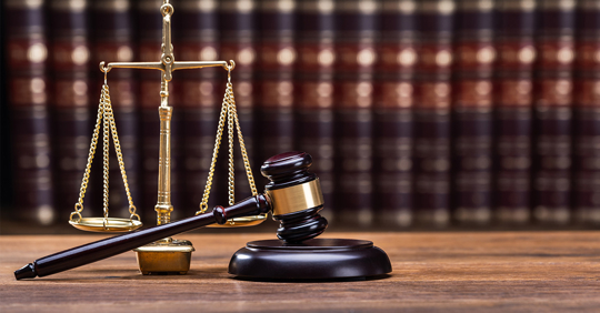 Gavel In Front Of Books With Golden Scale