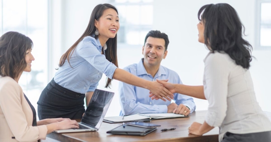 people shaking hands in conference room